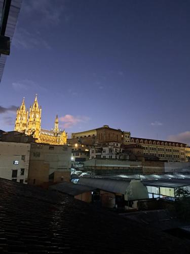 a group of buildings in a city at night at Casa CarpeDM in Quito