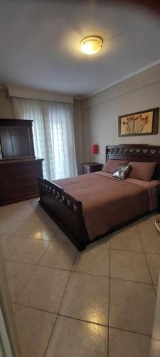 a bedroom with a large bed and a television at Comfortable and Elegant apartment FoFi in Thessaloniki