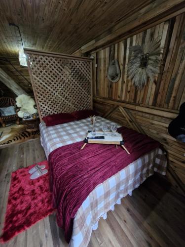 a bedroom with a bed with a book on it at Lauro Muller, Rancho Queimado in Louro Müller