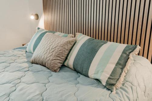 a bed with two pillows on top of it at Romantic Boutique Apartment 2 in Villajoyosa