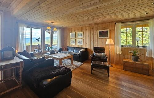 a living room with a couch and a table at Awesome Home In Eggedal With Sauna in Eggedal