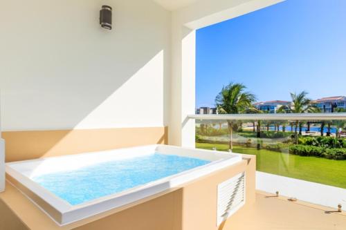 a hot tub on the balcony of a house at Luxury Condos at Mareazul Beachfront Complex with Resort-Style Amenities in Playa del Carmen