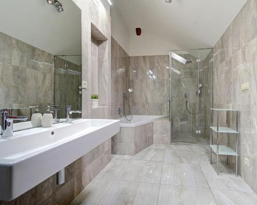 a bathroom with a tub and a sink and a shower at PENTHOUSe SUITE ABOVE in Prague