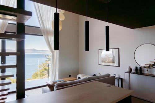 a living room with a view of the ocean at Studios del Susana - Dúplex Únicos y Exclusivos in Ushuaia