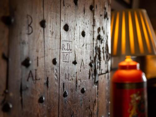 a wooden wall with writing on it next to a lamp at 5 Bed in Selkirk TOWER in Selkirk