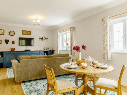 a living room with a table and a couch at 1 Bed in Aberdare 82906 in Merthyr Tydfil