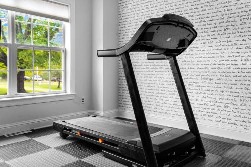 a treadmill in a room next to a wall at Luxury Mountain Retreat with Main House and Garage Apartment. Perfect for Families, Retreats and Remote Work in Sparta