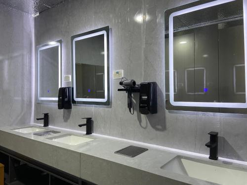 a public bathroom with two sinks and two mirrors at A1 Kaikoura Motel & Apartment in Kaikoura