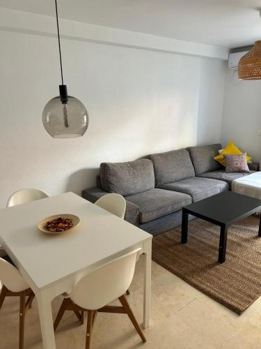 a living room with a white table and a couch at Capitán - 2 habitaciones centro de Fuengirola in Fuengirola