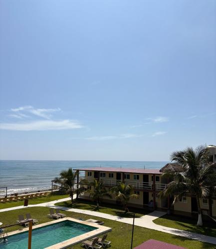 a view of a resort with a swimming pool and the ocean at Hotel La Roca Costa Esmeralda in Monte Gordo