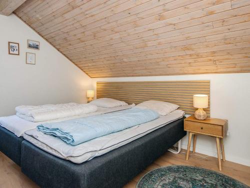 a large bed in a room with a wooden ceiling at Southern Charm in Rim - By Traum Ferienwohnungen in Sønderby