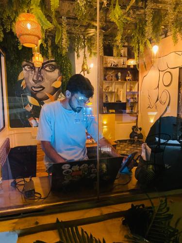 a man sitting in front of a mirror in a store at The Commune Banaras in Varanasi