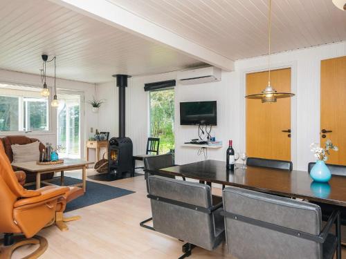 a living room with a dining table and a couch at Tranquil Retreat in Romo - By Traum Ferienwohnungen in Toftum