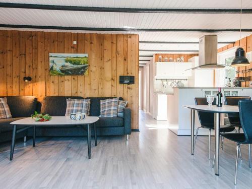 a living room with a couch and a table at 6 person holiday home in Rømø-By Traum in Bolilmark