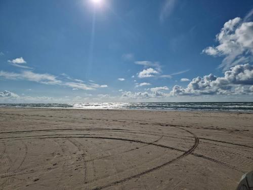 a circle in the sand on a beach at 9 person holiday home in Saltum in Saltum