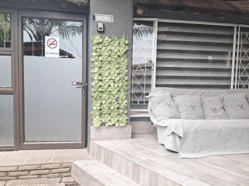 a couch sitting on the outside of a building at Bosveld In Die Stad Lodge in Alberton