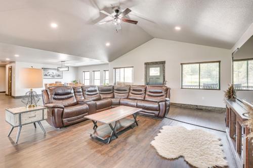 a living room with leather furniture and a ceiling fan at 4 Mi to Dtwn Sturgis Cabin with Hot Tub and Game Room in Crook City