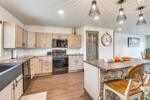 a kitchen with wooden cabinets and a counter top at 4 Mi to Dtwn Sturgis Cabin with Hot Tub and Game Room in Crook City