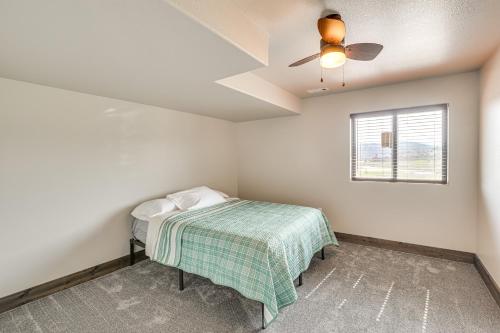 a bedroom with a bed and a ceiling fan at 4 Mi to Dtwn Sturgis Cabin with Hot Tub and Game Room in Crook City