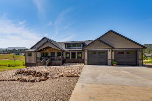 a large house with a garage and a driveway at 4 Mi to Dtwn Sturgis Cabin with Hot Tub and Game Room in Crook City