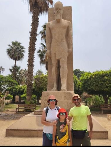 a group of people standing in front of a statue at Inside Pyramids Inn in Banī Ghālib