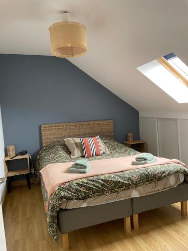a bedroom with a bed in a attic at brise marine in Le Crotoy
