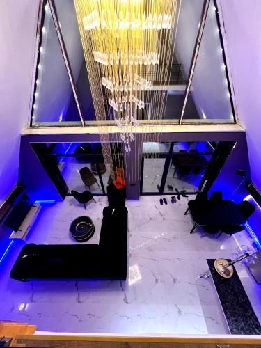 a room with a couch and a chandelier at AFrame Villa Riverside GABALA in Gabala