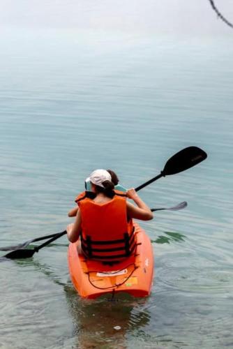 a person in a kayak in the water at Khaban Bacalar Hotel Boutique in Bacalar