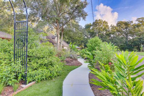 a walkway in a garden with plants at Peaceful Fairhope Getaway, 2 Mi to South Beach in Fairhope