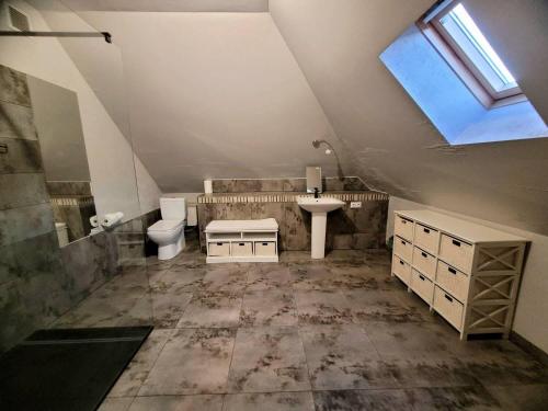 a bathroom with a sink toilet and a window at Chata pod Śnieżnikiem in Nowa Morawa