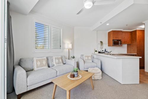 a living room with a couch and a table at Crystal Bay On The Broadwater in Gold Coast