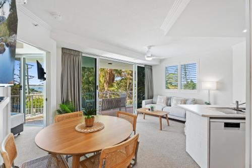 a kitchen and living room with a table and chairs at Crystal Bay On The Broadwater in Gold Coast