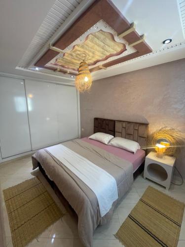 a bedroom with a bed with a painting on the ceiling at Papaya Hostel in Agadir