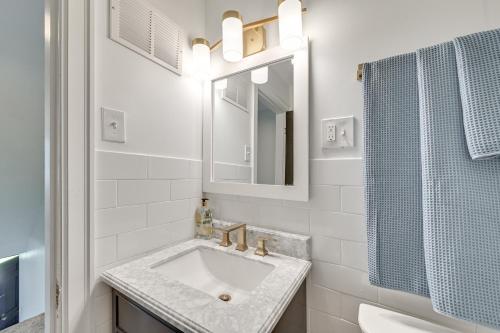 a white bathroom with a sink and a mirror at 3 Mi to Dtwn Updated Home with Hot Tub in Lexington in Lexington