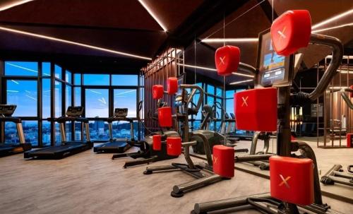 a gym with cardio equipment in a building at The Edge Infinity in Pattaya