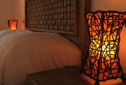 a lamp sitting next to a bed in a room at Villas Mexiko in Tepoztlán