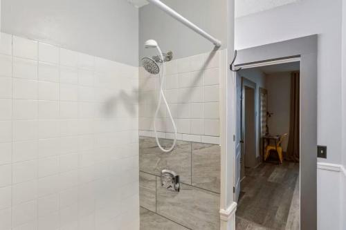 a dog standing in a shower in a bathroom at W38 Whole House in Cleveland