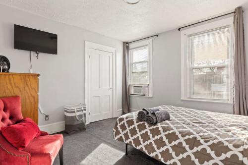 a bedroom with a bed and a red chair at W38 Whole House in Cleveland