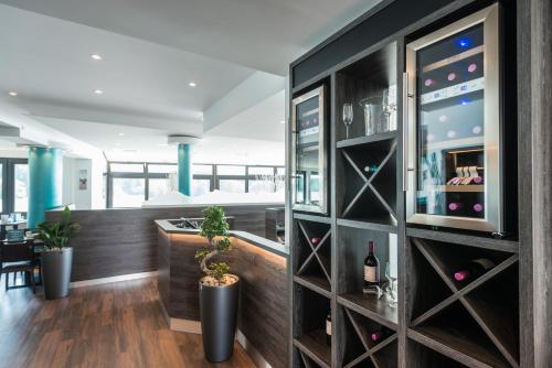 a wine cellar with a wall of wine bottles at Rheinterrassen Hotel Café Restaurant in Widdig