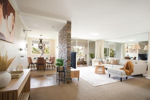 a living room with a couch and a table at 3BR Apartment Near Bondi with Pool and Parking in Sydney