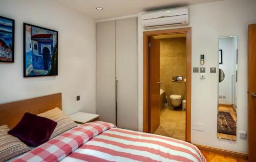 a bedroom with a bed and a bathroom at Rock view Apartment at ocean village in Gibraltar