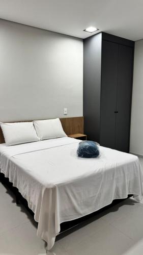 a large white bed in a white room with at Studios Gago 167 in Suzano