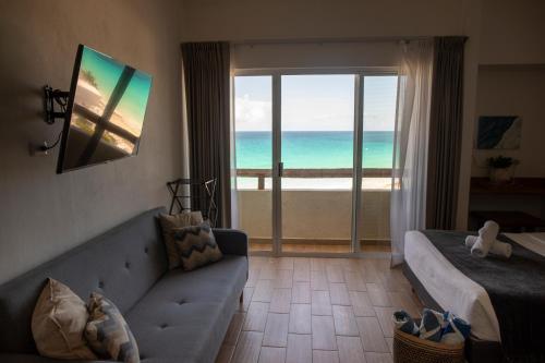 a living room with a couch and a view of the ocean at OceanView & Beach Access 3805 in Cancún