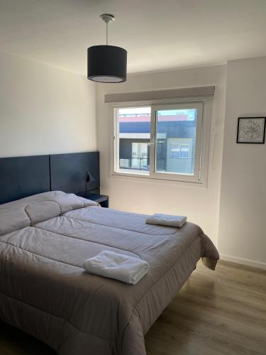 En eller flere senge i et værelse på Departamento Sierras Cordobesas