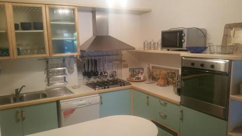 a kitchen with a sink and a stove top oven at Villetta Punta Ala in Punta Ala