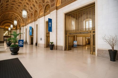 an empty lobby of a building with potted plants at Luxe Downtown Suite Stadiums, Casino, R&R Hall! in Cleveland