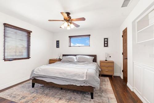 a bedroom with a bed and a ceiling fan at Silverstrand Beach House in Oxnard