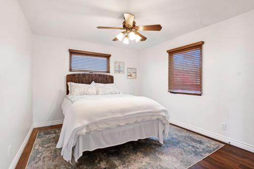 a bedroom with a bed and a ceiling fan at Silverstrand Beach House in Oxnard