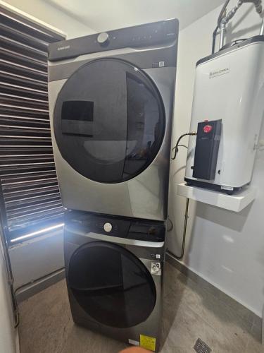 a large television is sitting next to a appliance at Ground floor condominium at the foot of the pool in Playa del Carmen