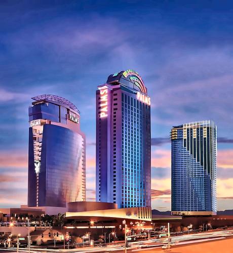 three tall buildings in a city at dusk at Luxury Suites at Palms Place in Las Vegas